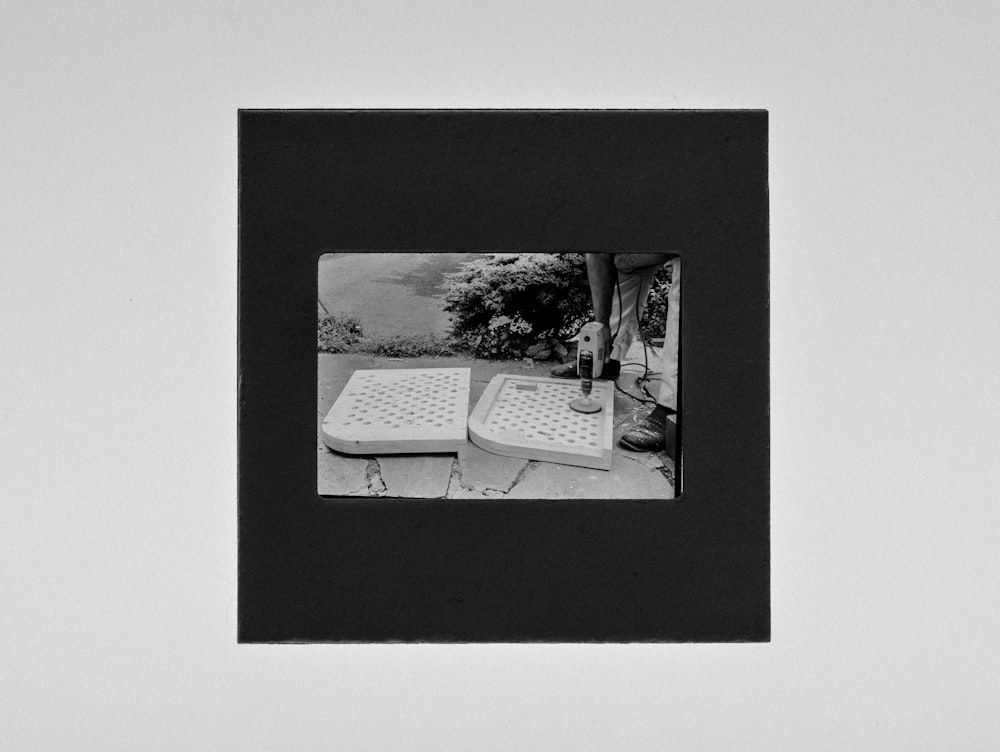 grayscale photo of man and woman on white table