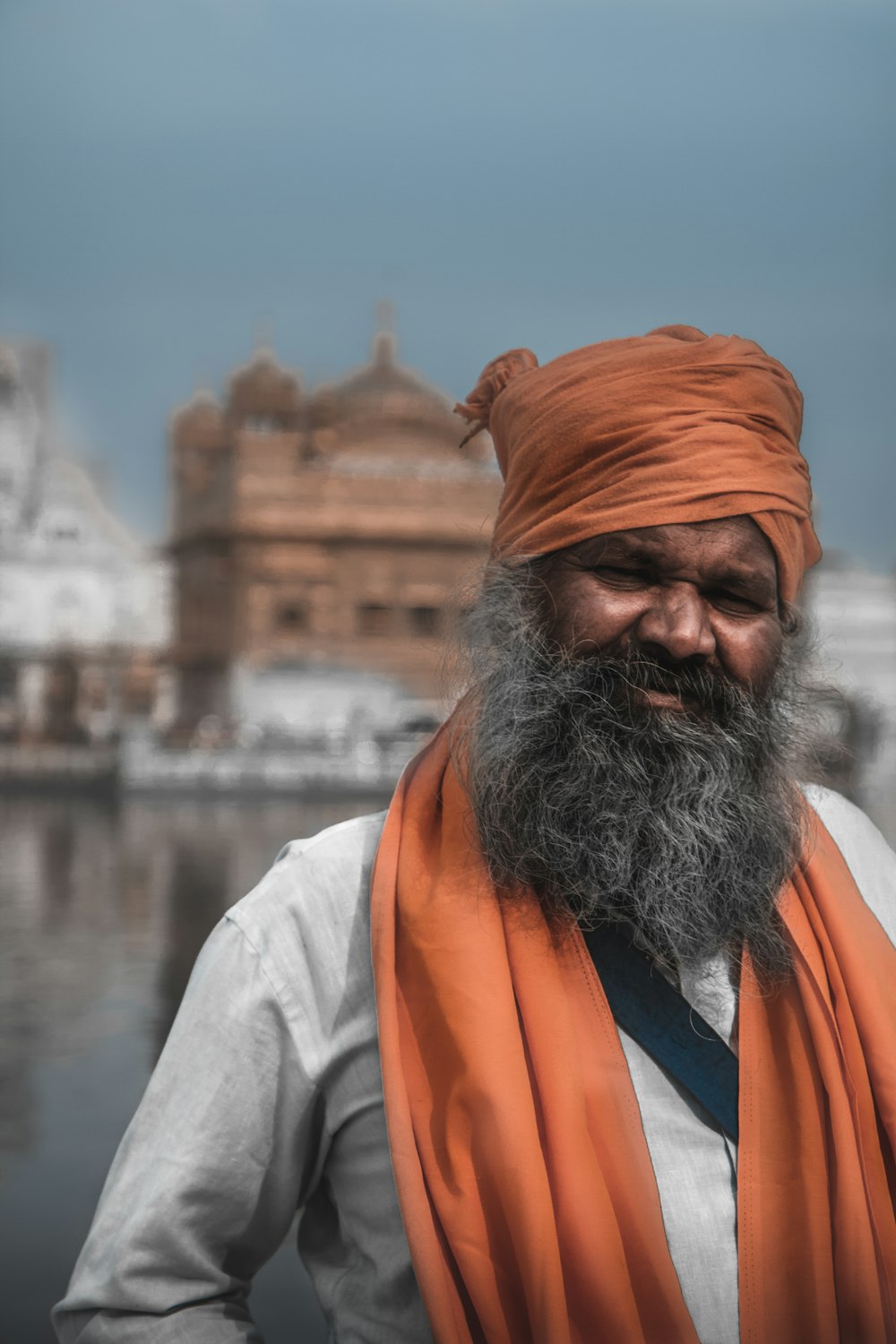 man in orange and white scarf