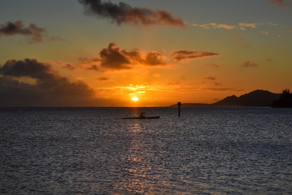 silhouette of people on beach during sunset