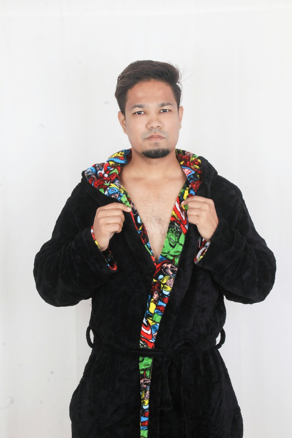 woman in black jacket standing near white wall