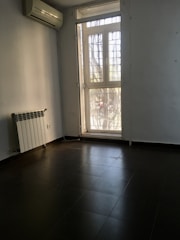 A bright, airy room with an air conditioning unit.