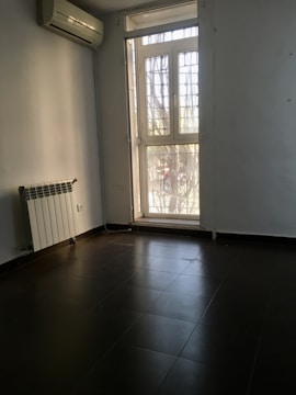 A bright, airy room with an air conditioning unit.