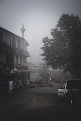 A roadside scene with a car emitting steam from the hood and a concerned man standing beside it, set against a backdrop of Florence, SC.