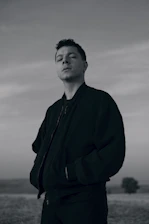 A person smiling confidently outdoors, feeling free and relieved from anxiety.