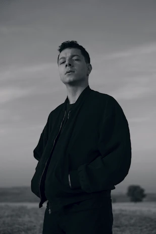 A person smiling confidently outdoors, feeling free and relieved from anxiety.