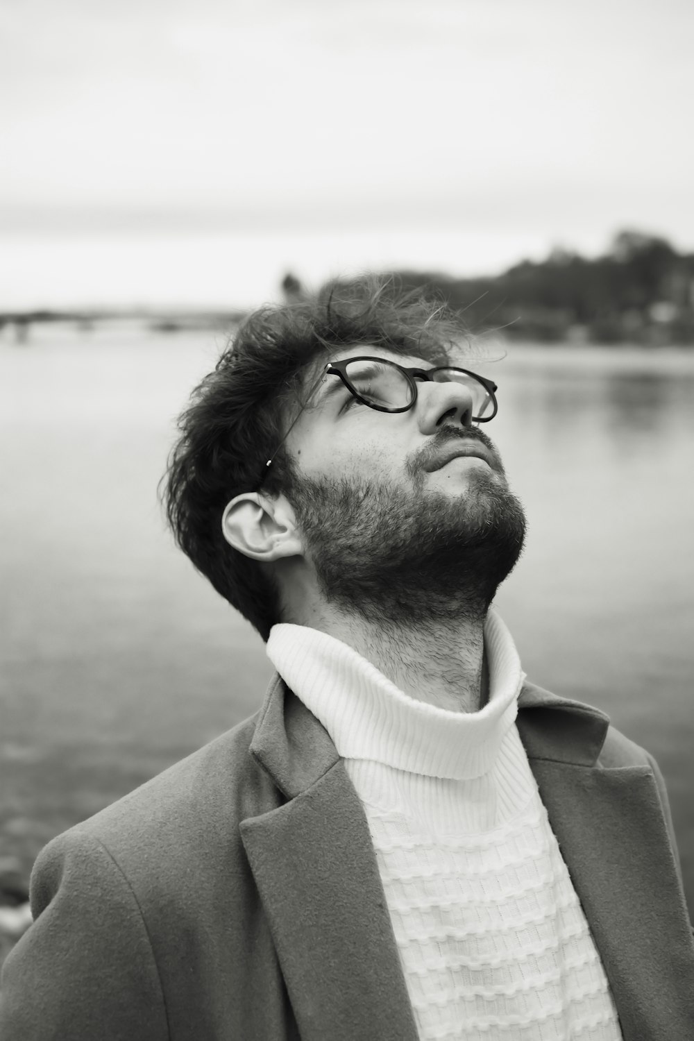 man in black coat wearing black framed eyeglasses