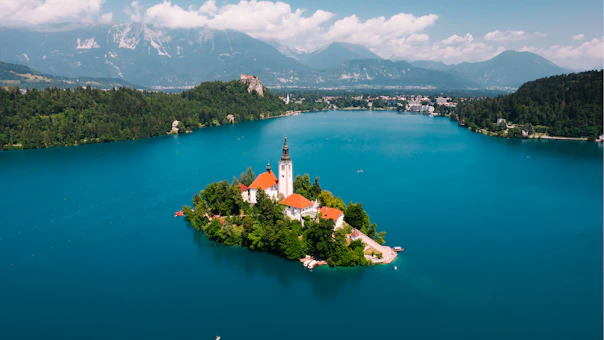 aerial view of white and brown concrete building near body of water during daytime