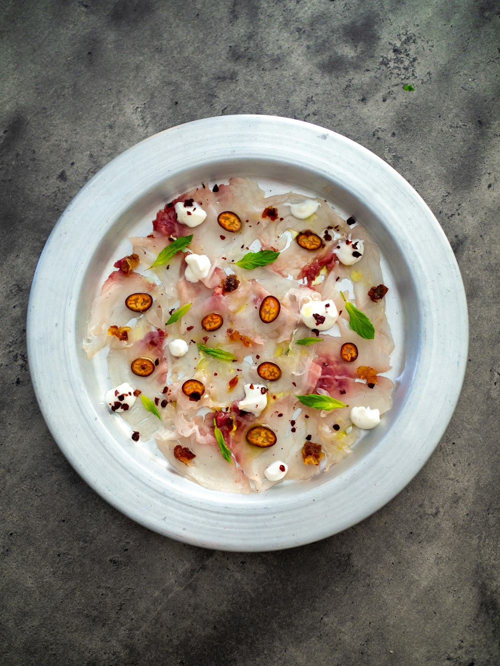 sliced fruits in white round bowl