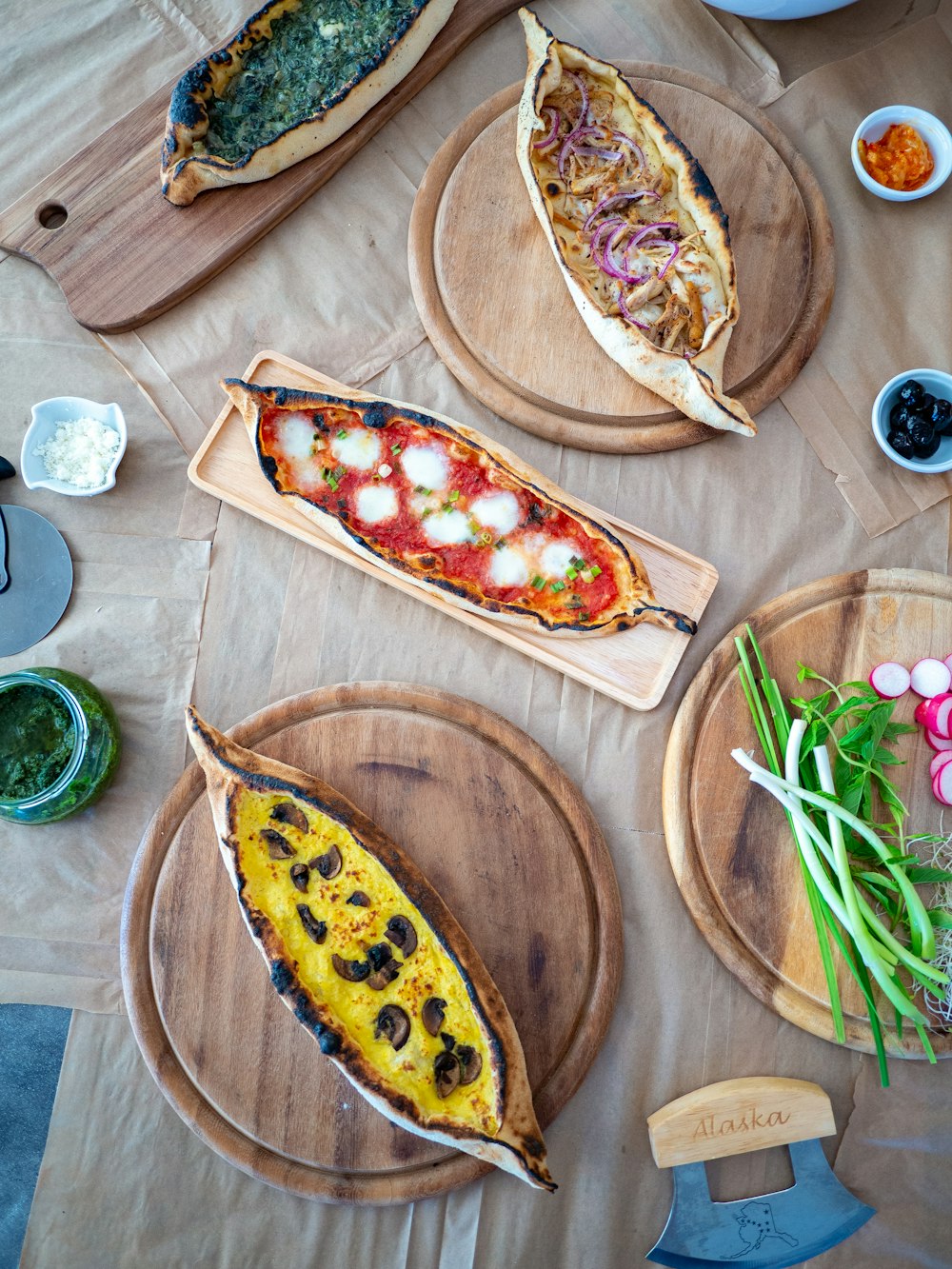 sliced pizza on brown wooden round plate