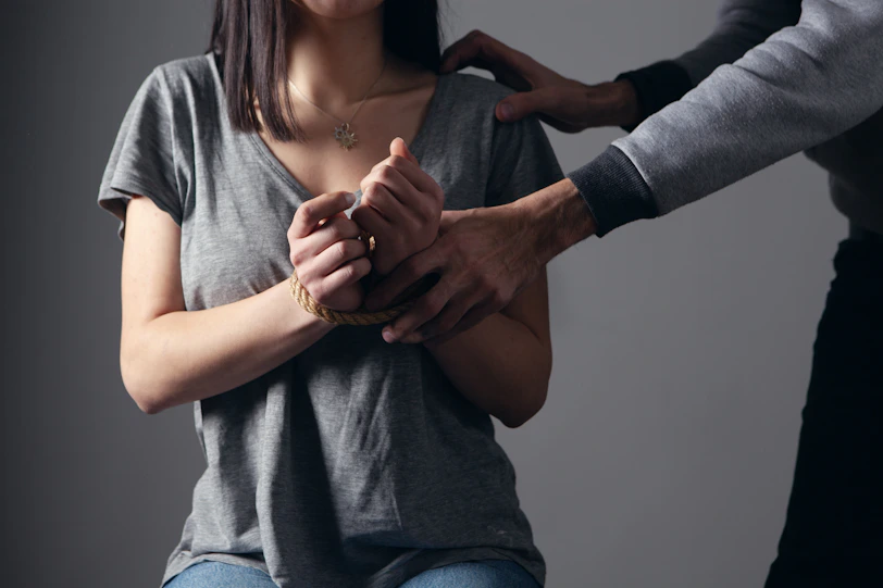woman in gray scoop neck shirt holding her hands