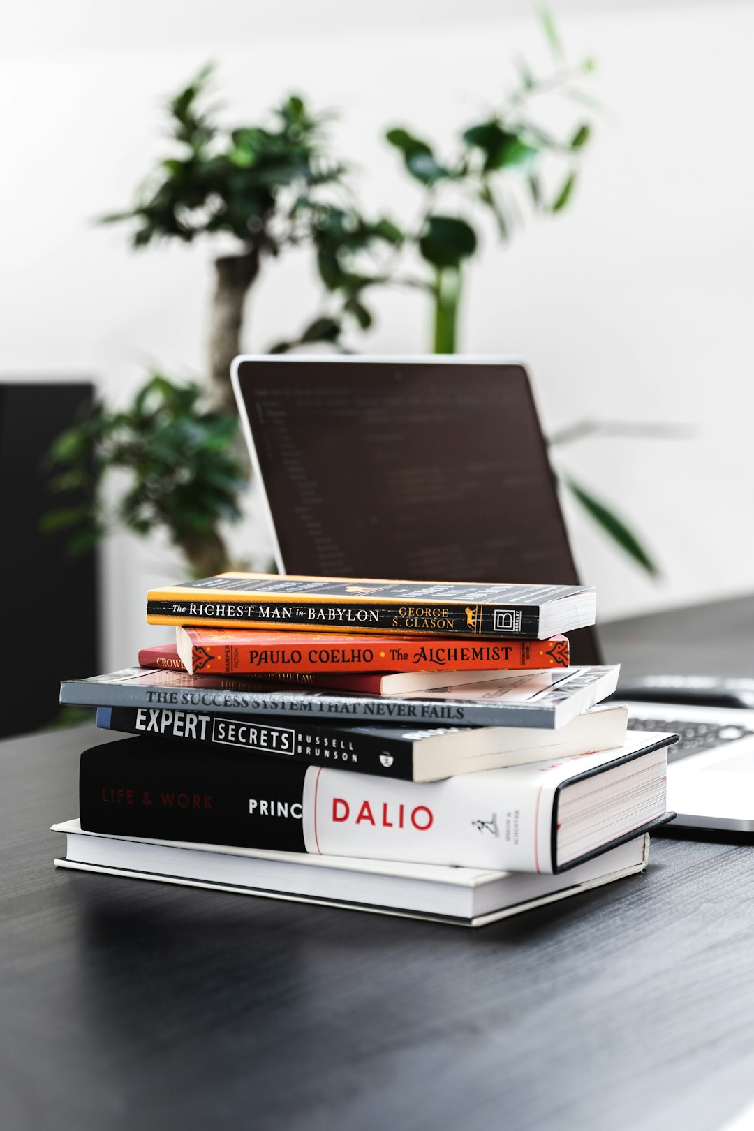 black and red hardbound books on white table