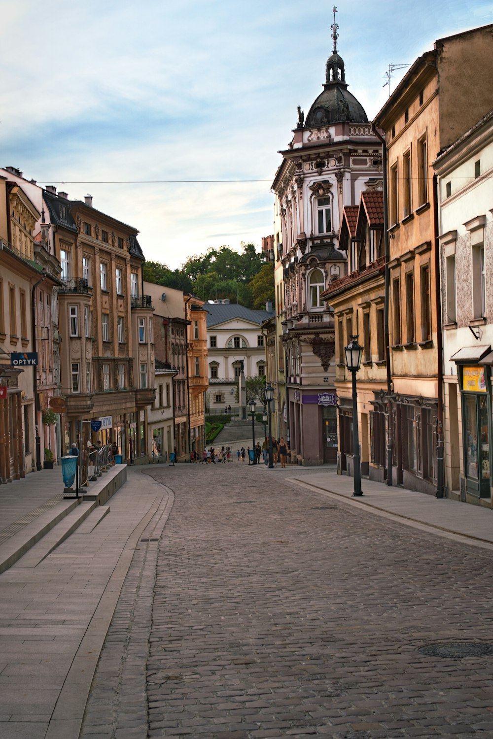 people walking on sidewalk near buildings during daytime