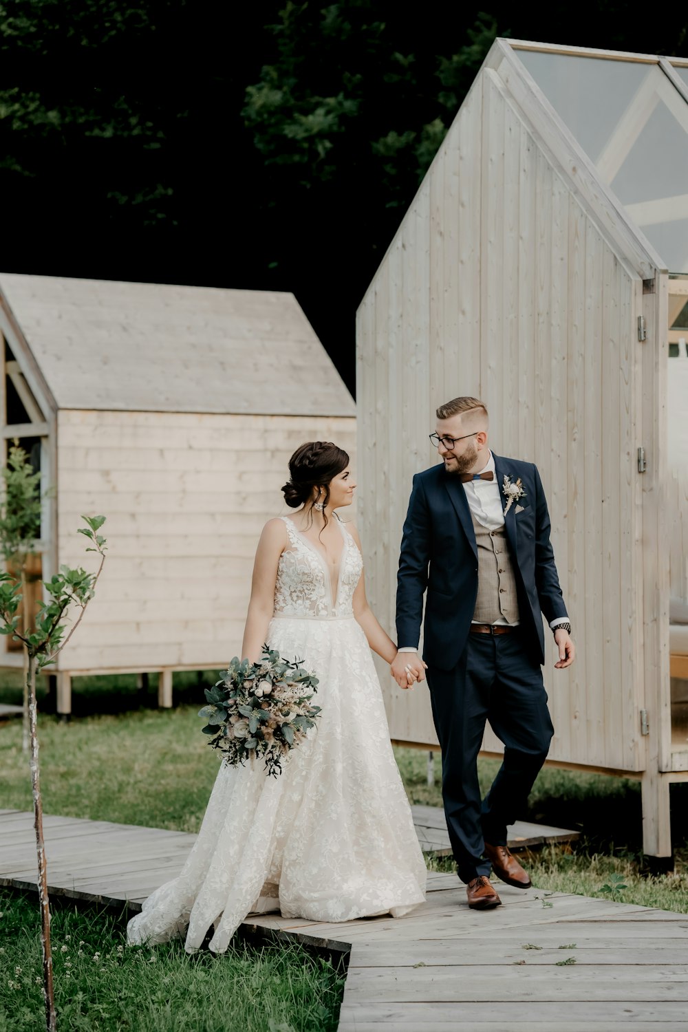 man in black suit and woman in white wedding dress