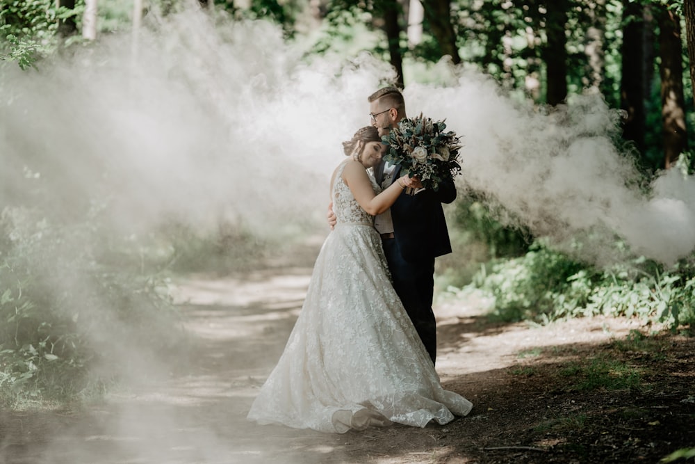 woman in white wedding gown holding bouquet of flowers