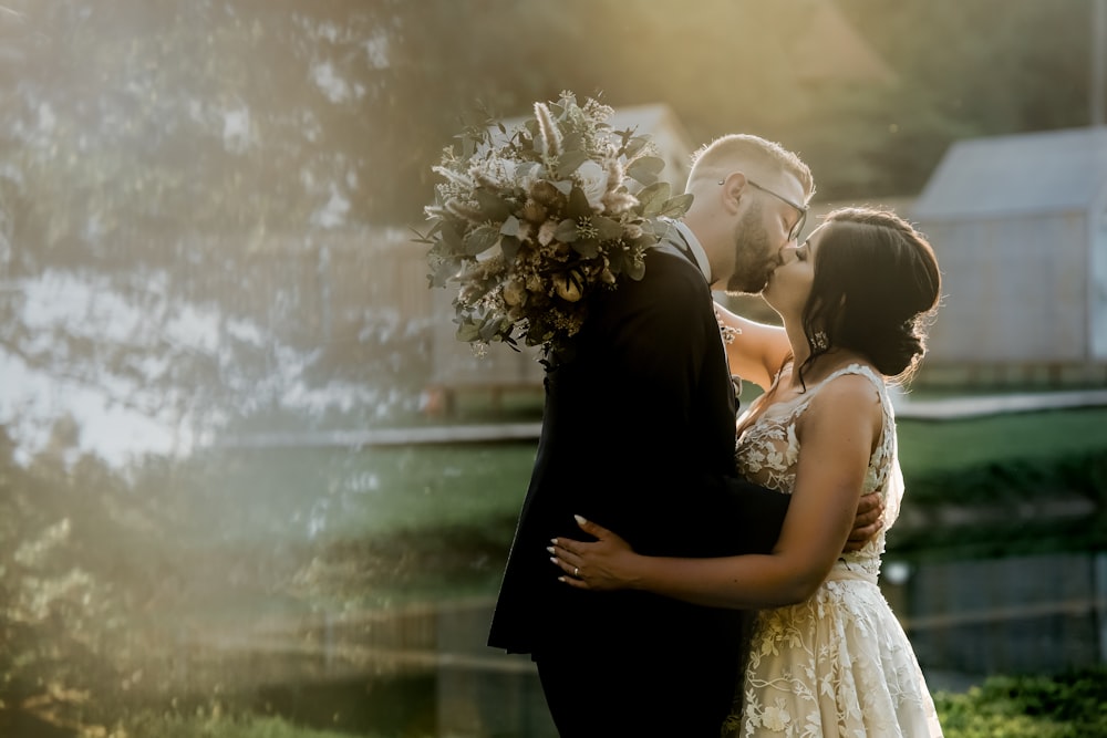 bride and groom holding bouquet of flowers