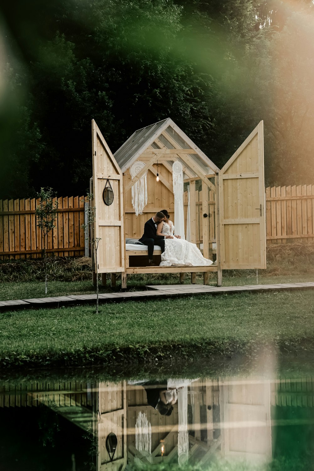 woman in white dress sitting on brown wooden bench