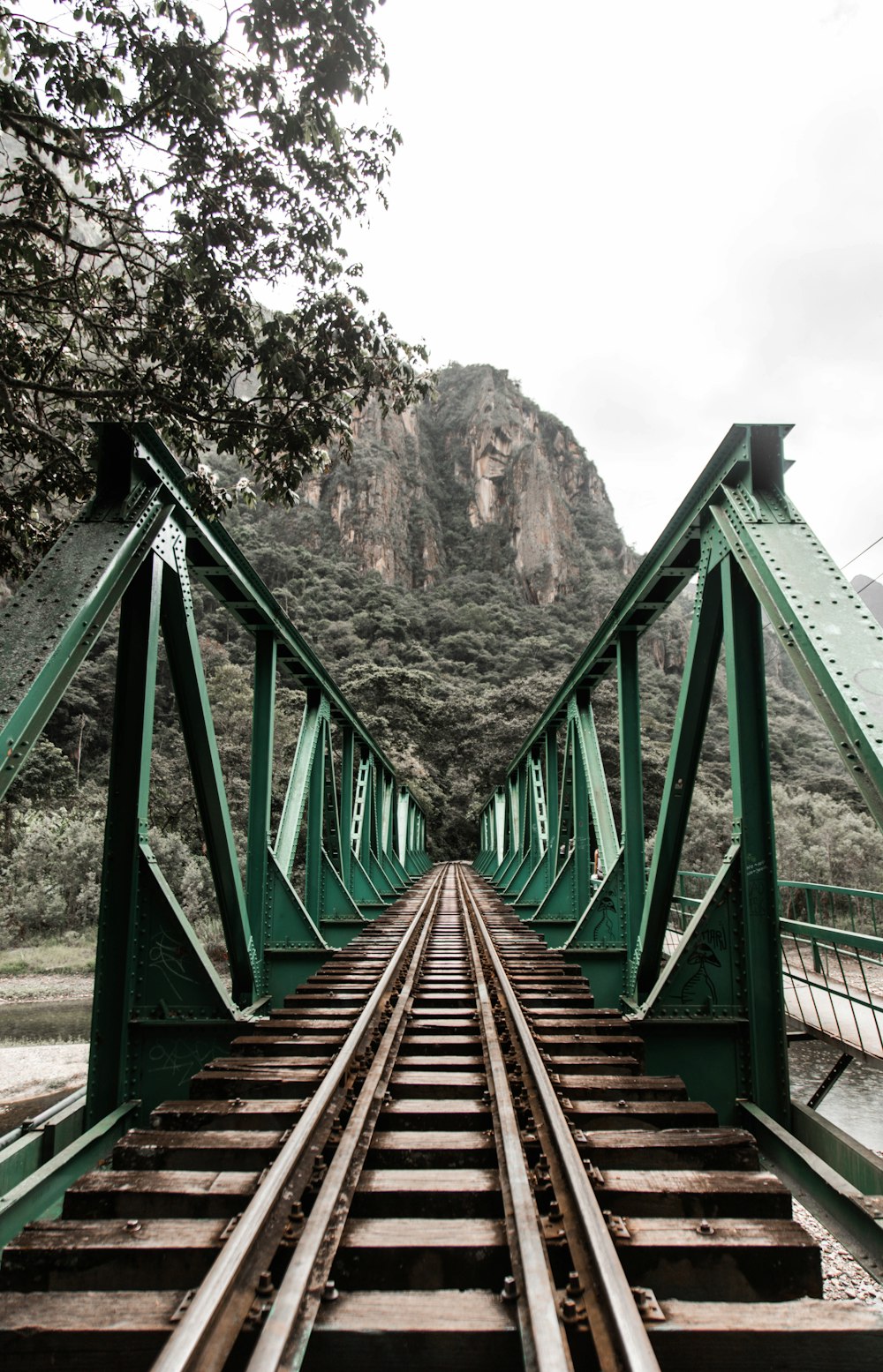 brown wooden bridge near brown mountain during daytime