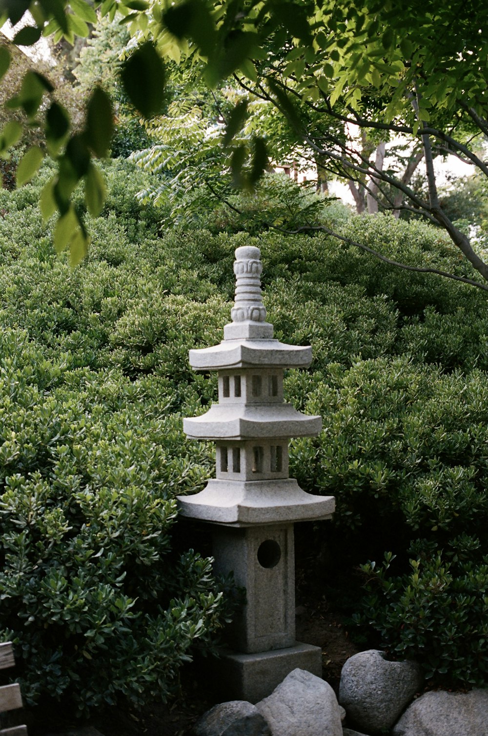 white concrete tower surrounded by green trees during daytime