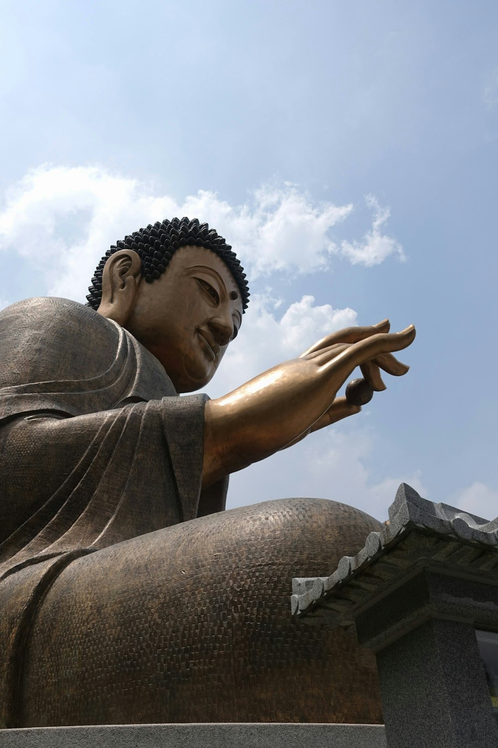 man in grey shirt raising his hands