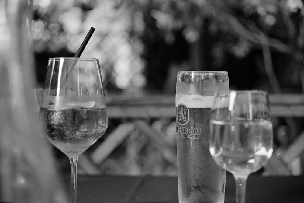 grayscale photo of clear drinking glass beside clear drinking glass