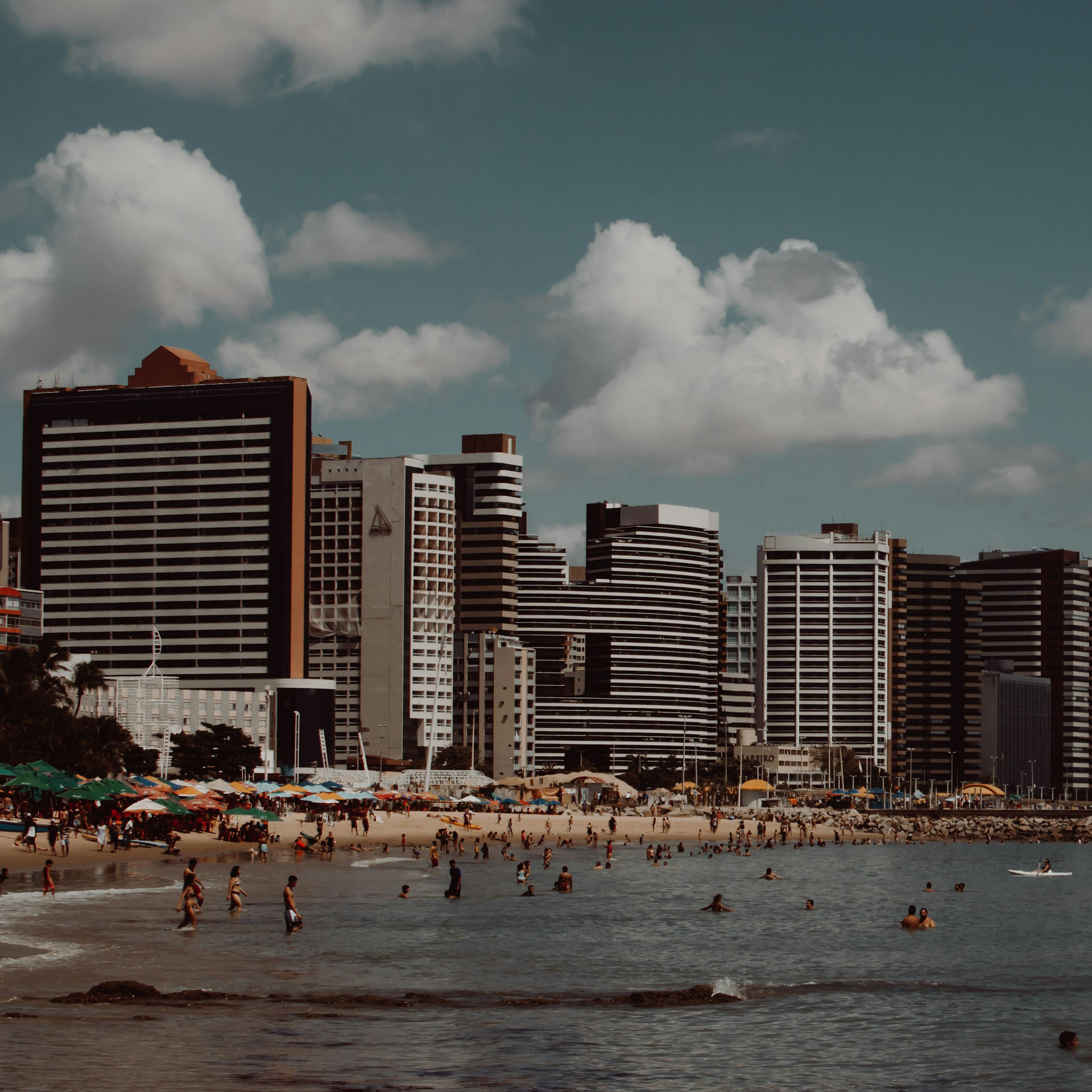 People on beach near high rise buildings during daytime photo – Free ...