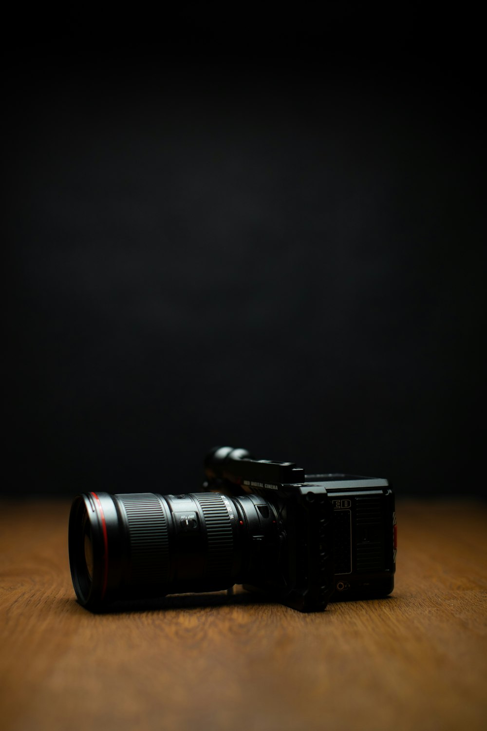 black dslr camera on brown wooden table