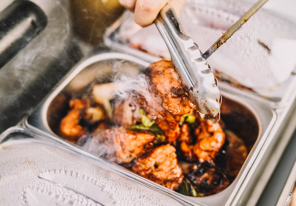 person holding stainless steel fork and knife