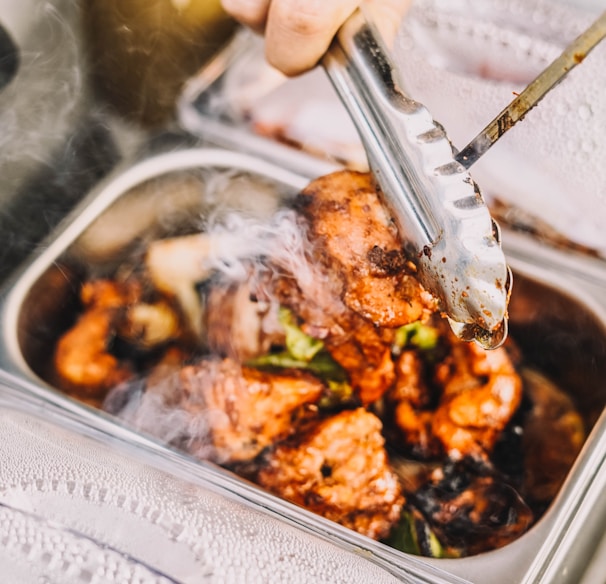 person holding stainless steel fork and knife