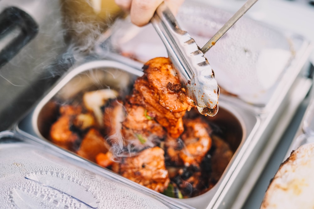 person holding stainless steel fork