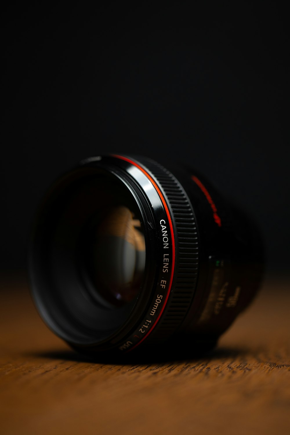 black camera lens on brown wooden table