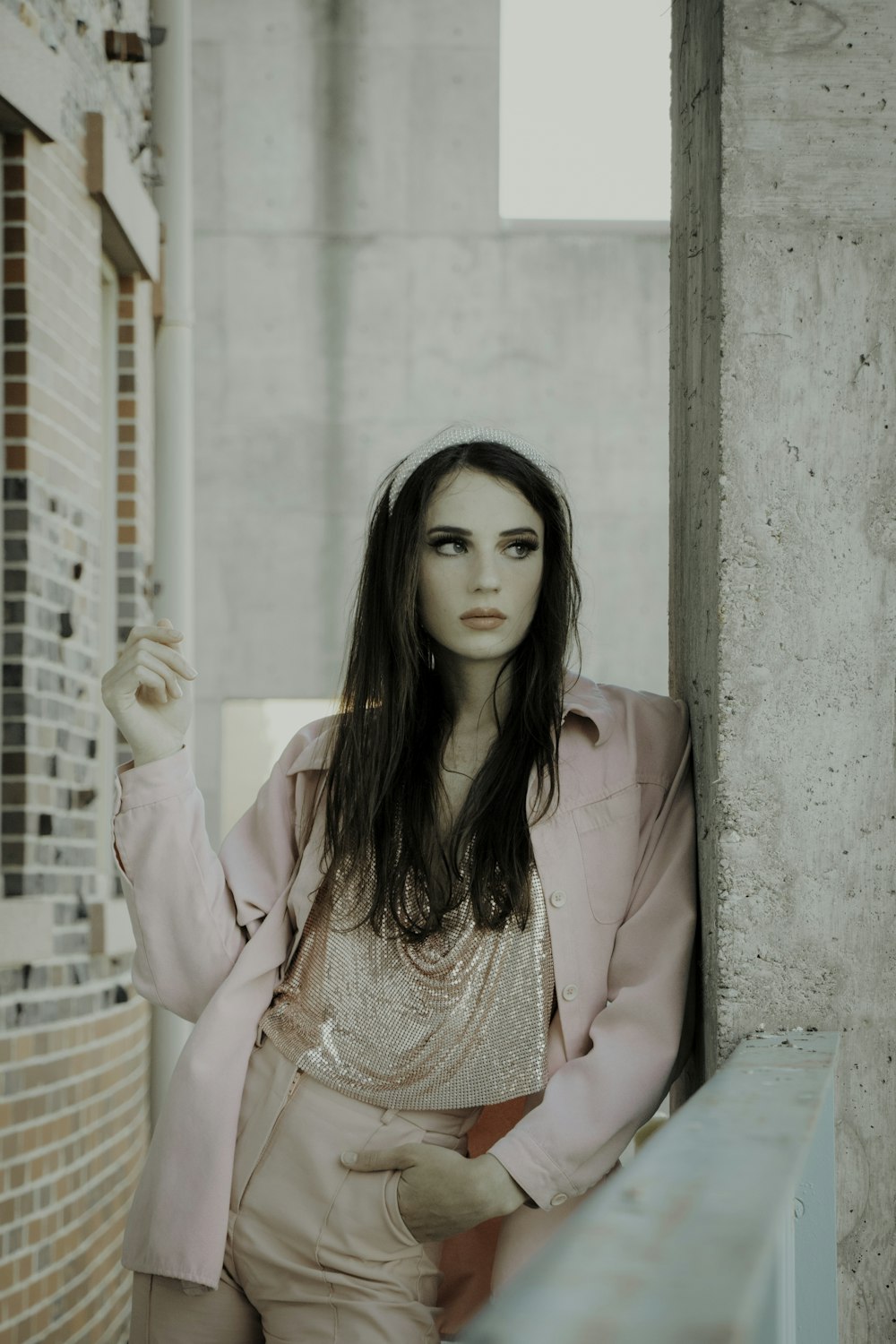 woman in pink blazer sitting on bench