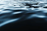 Abstract monochrome photo of rippling water reflecting light.
