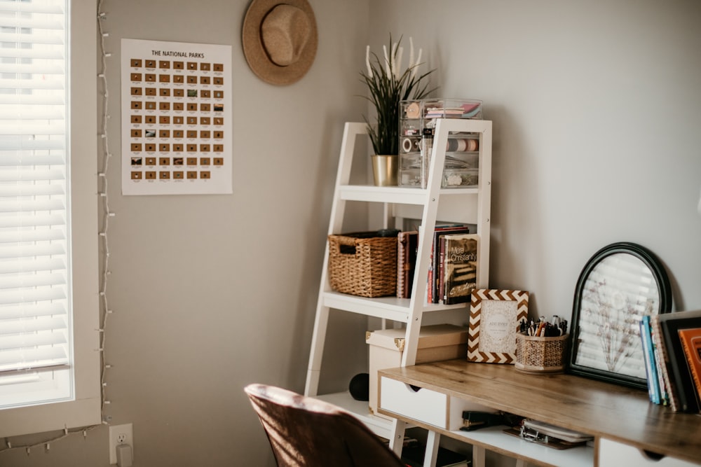 white wooden shelf with books and brown wicker basket