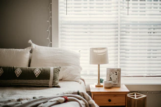 white and gray throw pillow on bed