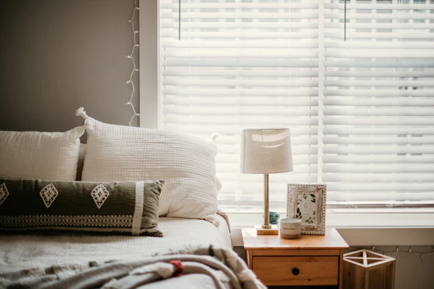 white and gray throw pillow on bed
