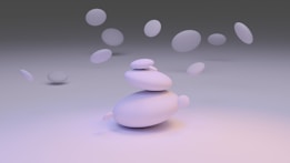 A minimalist arrangement of smooth, rounded stones, with several stones hovering and floating around them. The background is a gradient of soft, muted colors, giving a serene and tranquil ambiance.