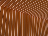 Uniform vertical and horizontal lines create a geometric pattern, forming an angular ceiling and wall design with an illusion of depth.