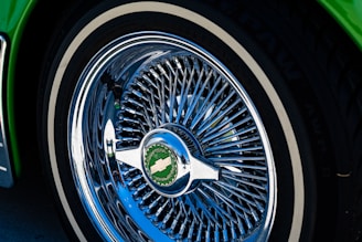 Close-up of shiny aftermarket rims for Chevrolet pickups displayed in a showroom.