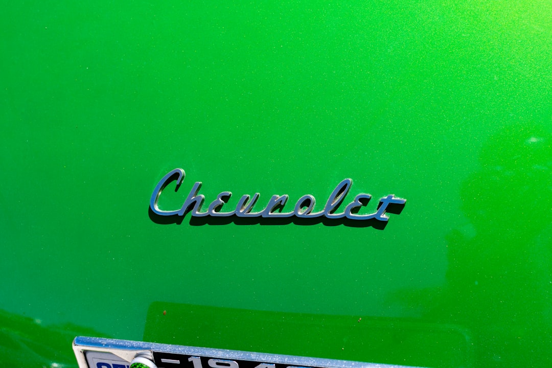 a close up of the emblem on a green car,