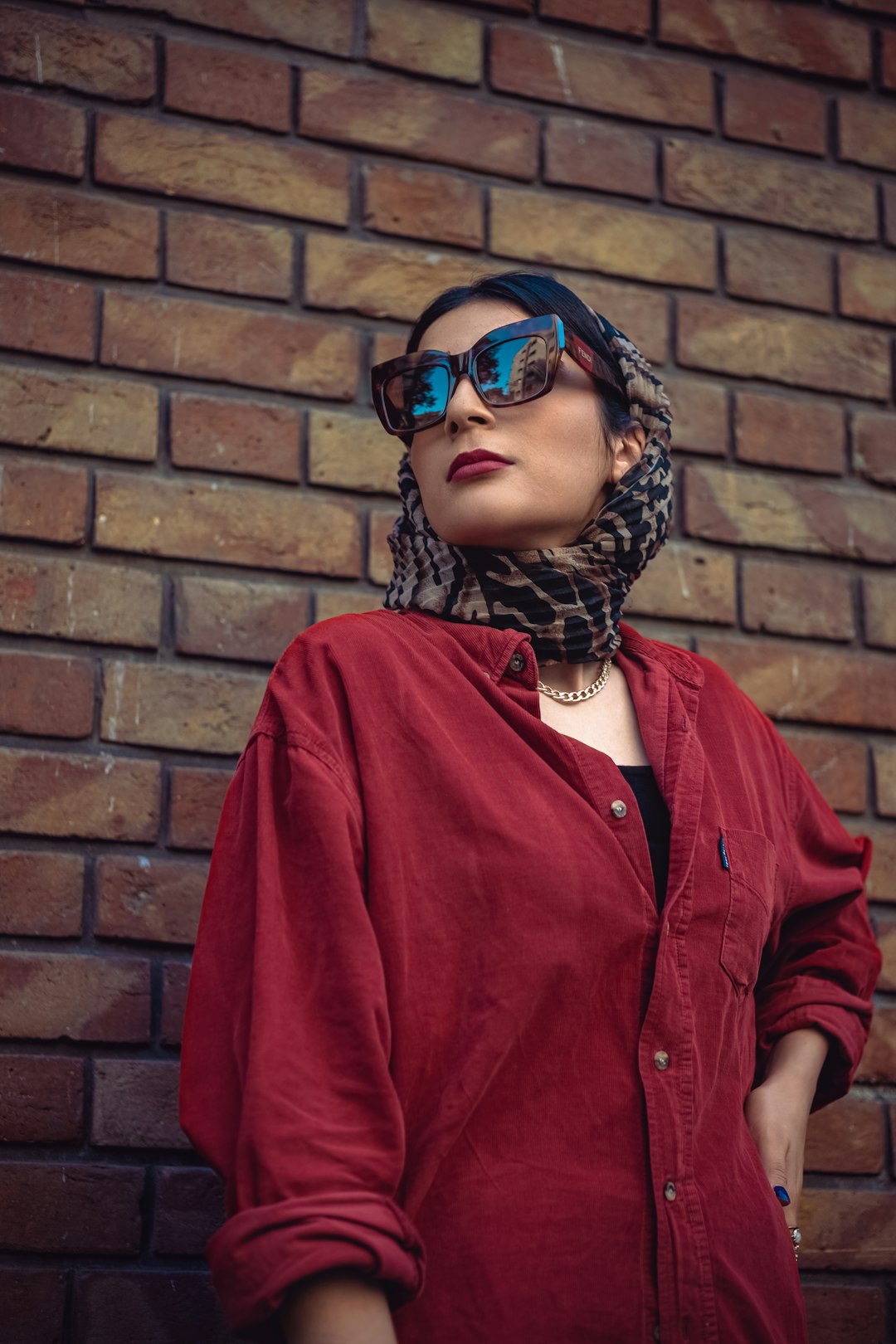 woman in red button up long sleeve shirt wearing black sunglasses