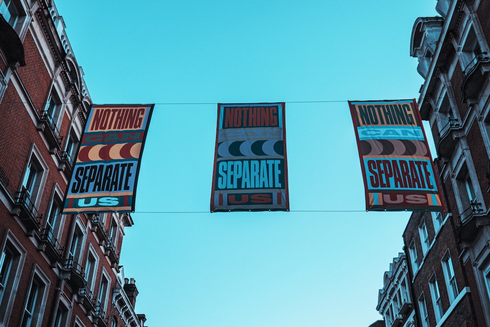 a couple of banners hanging from a wire