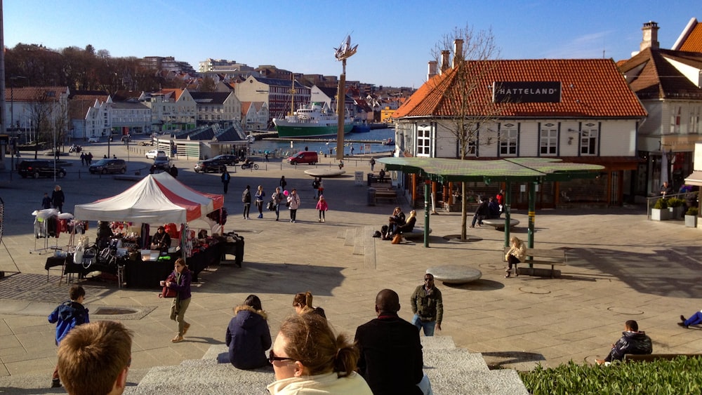 people sitting on bench near body of water during daytime