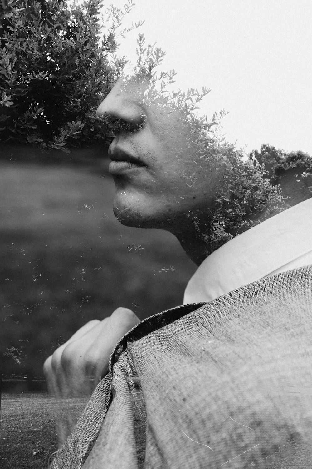 grayscale photo of man in black and white shirt