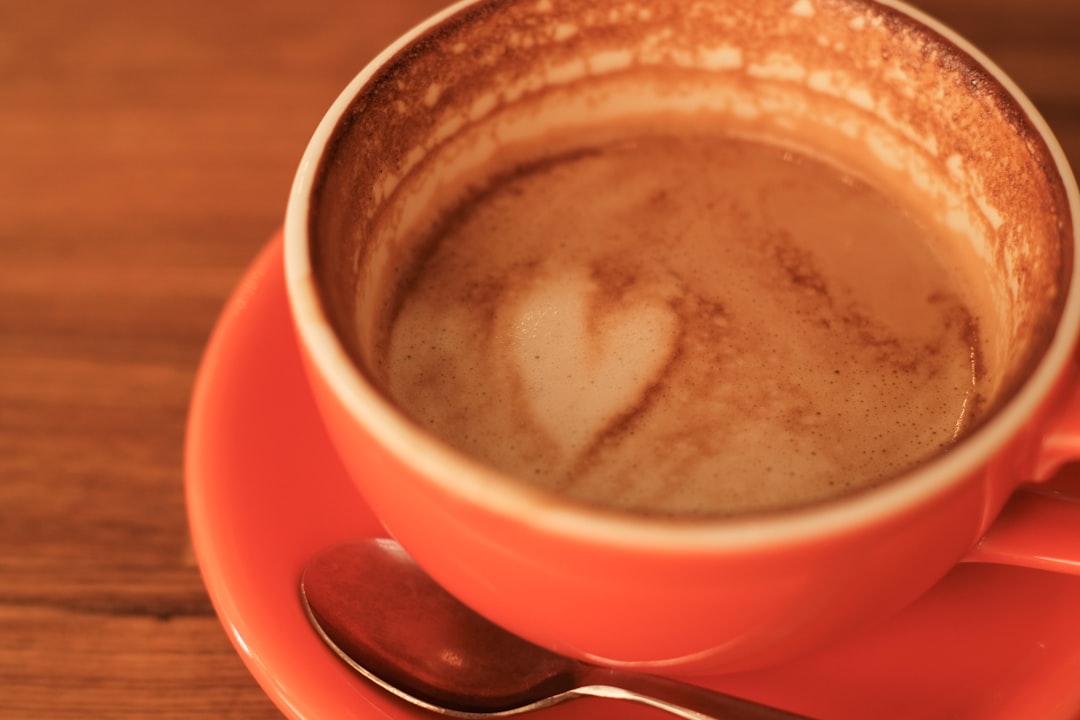 red ceramic mug with brown liquid