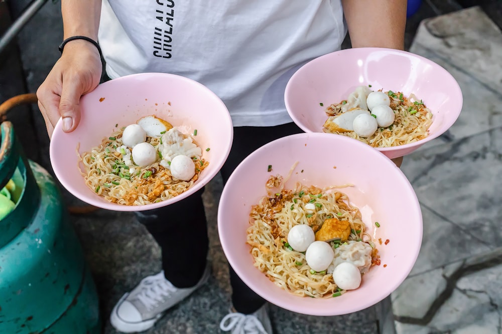 person holding white ceramic bowl with eggs