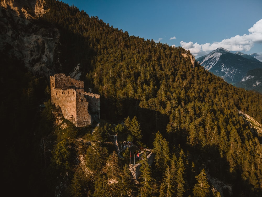 brown concrete building on top of mountain during daytime