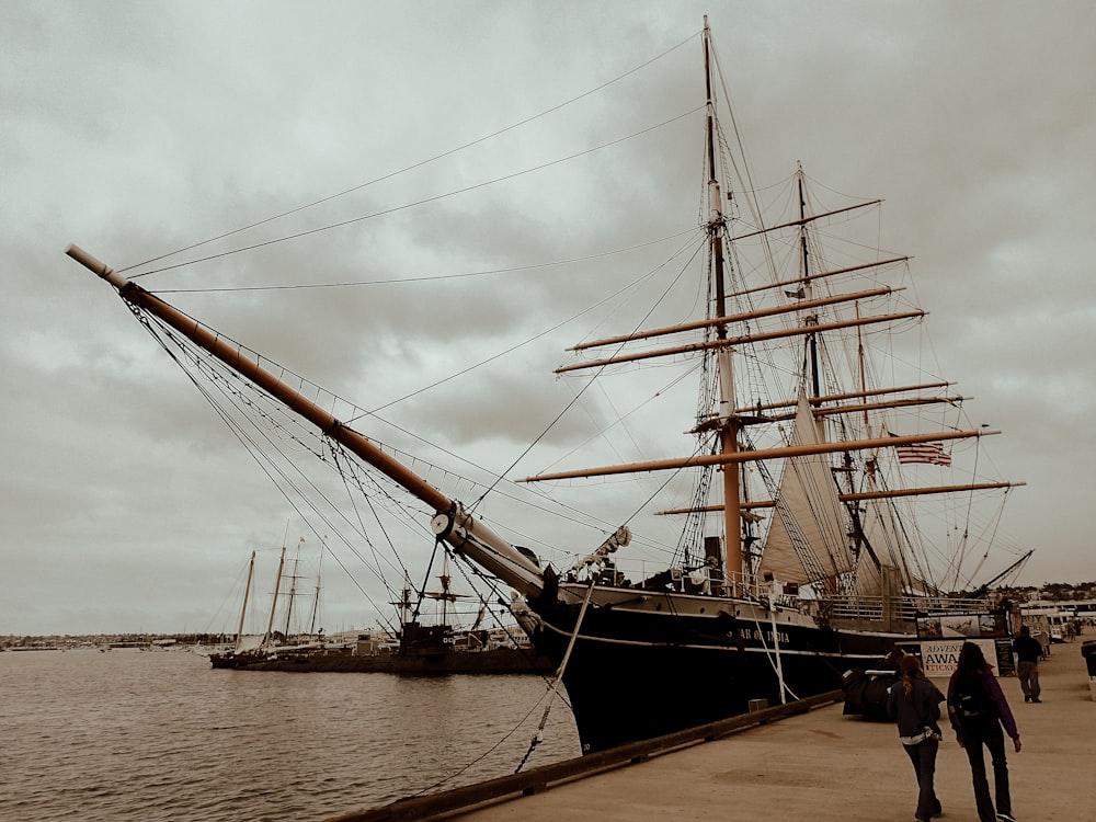 black sail ship on sea during daytime