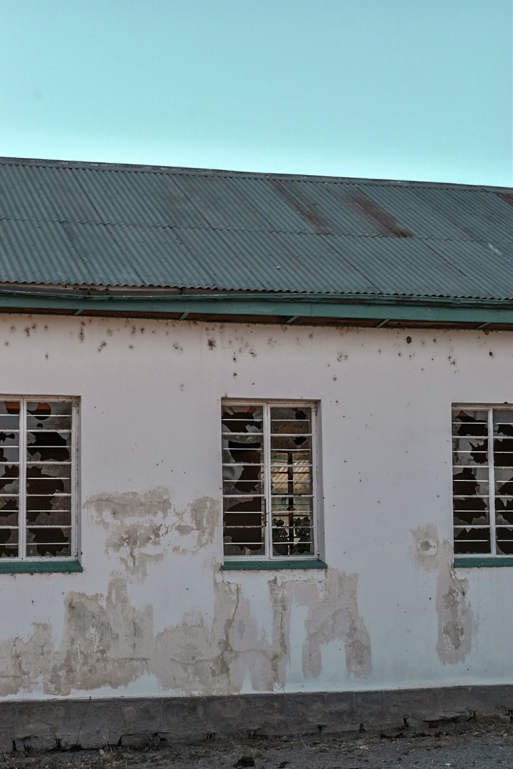 white concrete house with white wooden window