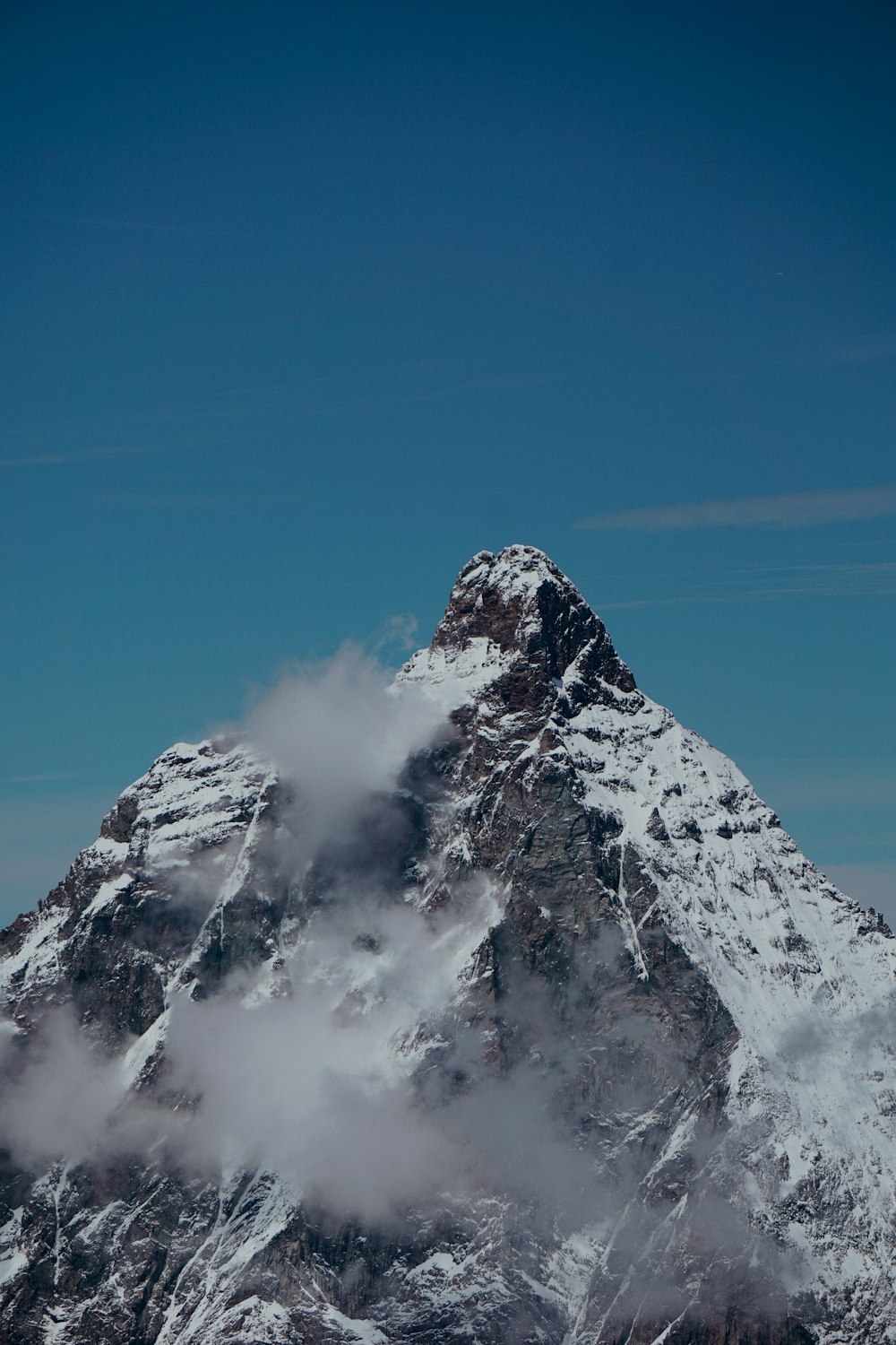 montanha coberta de neve sob o céu azul durante o dia