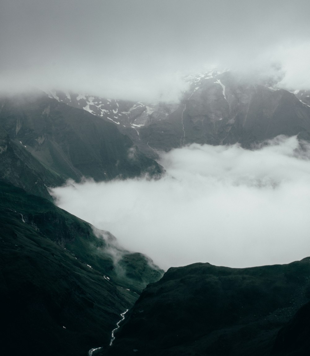 black and white mountains under white clouds